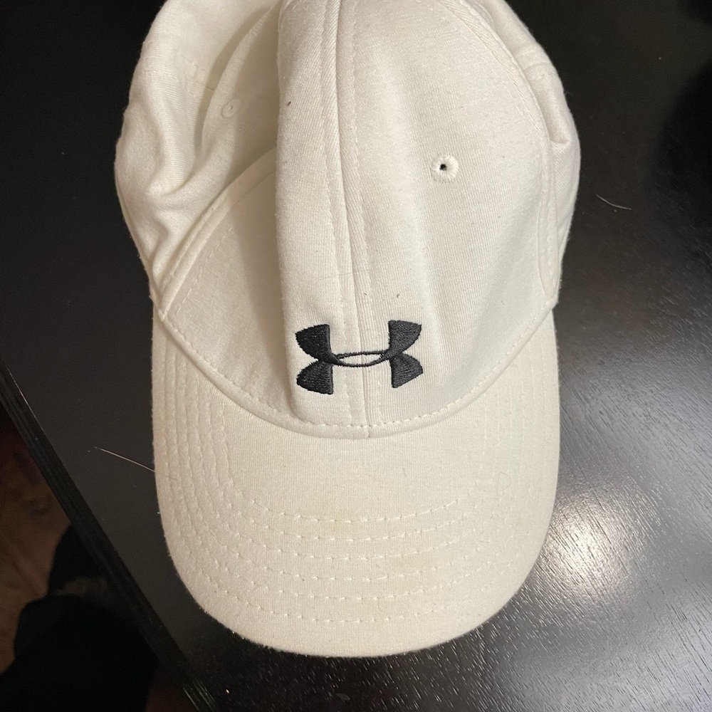 White under armor hat, hole in back for pony tail. See pics. Black logo